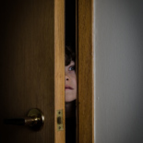 stock-photo-65631363-boy-peeking-through-closet-door-with-fear